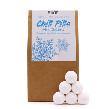 A kraft gift pouch filled with small, spherical white bath bombs decorated with a winter-themed Chill Pills sticker.