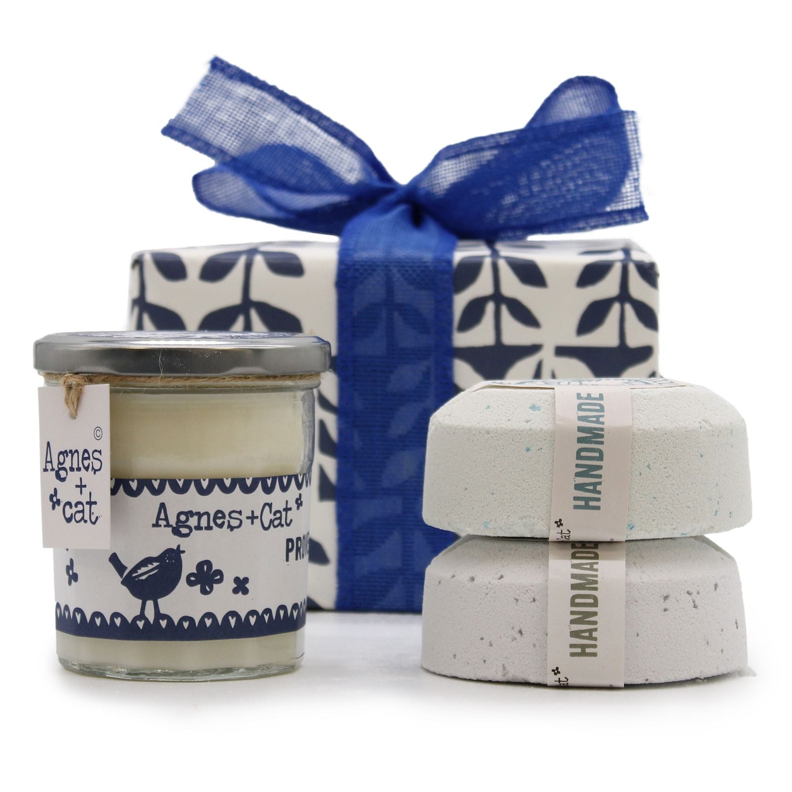 A luxury gift box arrangement containing a Parma Violet candle and multiple artisan bath fizzers with a blue ribbon.