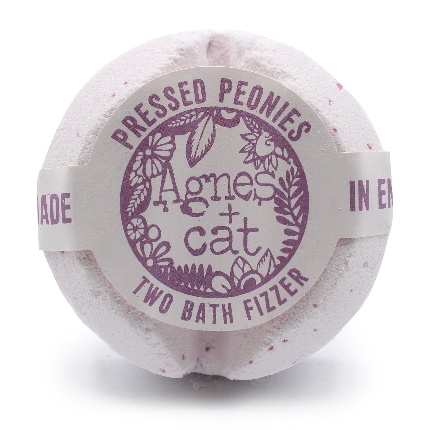 A large, round white bath fizzer wrapped in clear film with a sophisticated purple and white floral label.