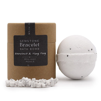 A 170g white bath bomb with a white Jasper gemstone bracelet displayed as a hidden treasure inside, perfect for spiritual gifting.