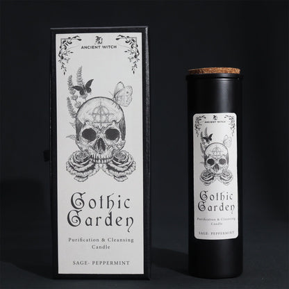A tall black ritual candle in a premium black box with white Victorian-style gothic botanical illustrations.