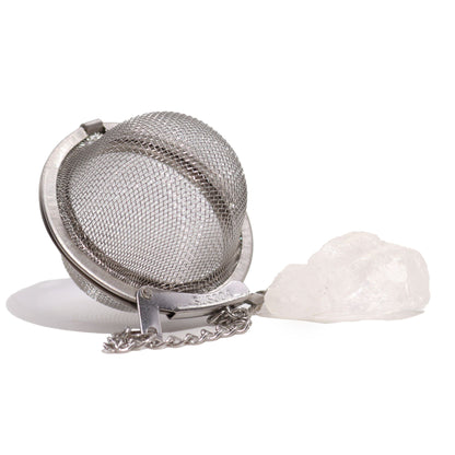 Stainless steel mesh tea infuser ball with a raw clear rock quartz gemstone charm hanging on a silver chain.