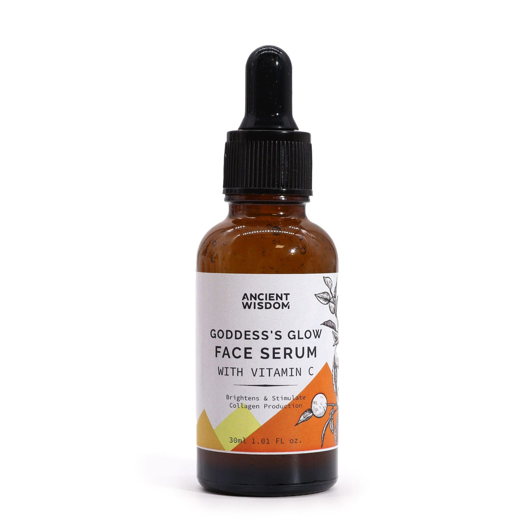 An amber glass dropper bottle of Vitamin C face serum with a luxury white and gold label.