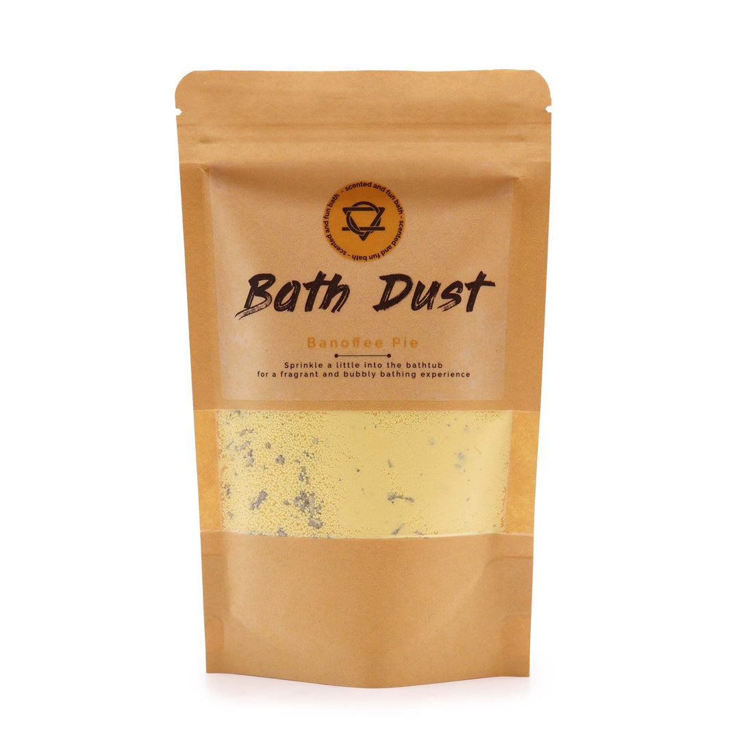 A stand-up kraft paper pouch containing yellow and cream-colored aromatic bath fizzing dust with a dessert-themed label.