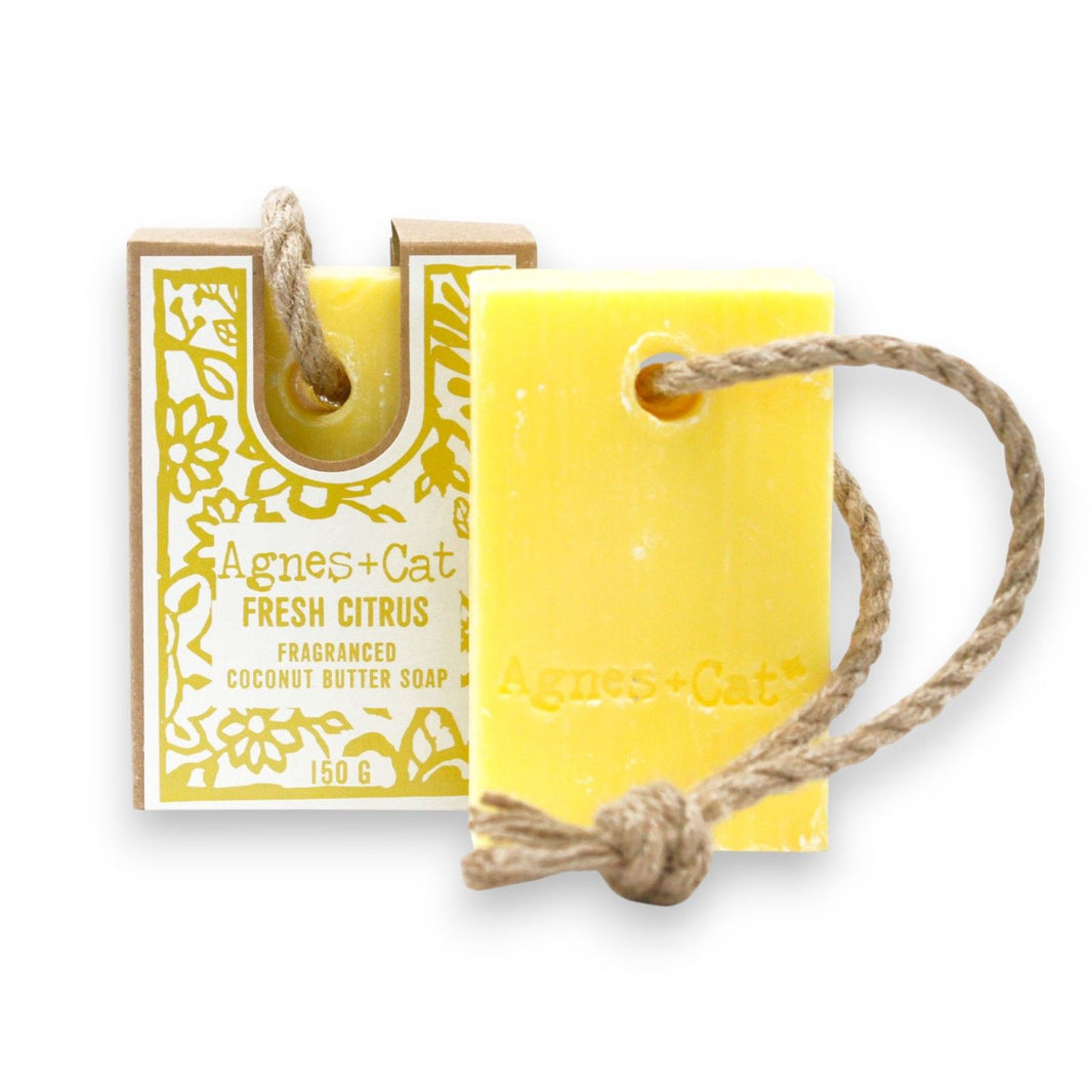 A 150g bar of bright yellow and cream artisan soap on a natural hanging rope with a fresh citrus fragrance.