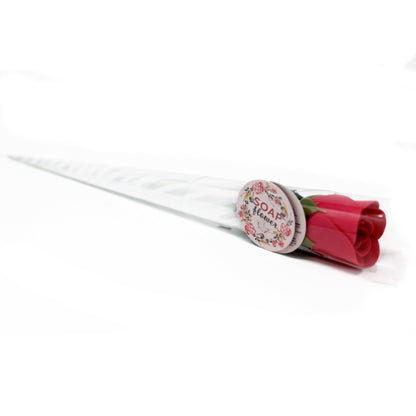 A small red soap flower shaped like a rose, presented as a single bloom for bath use.