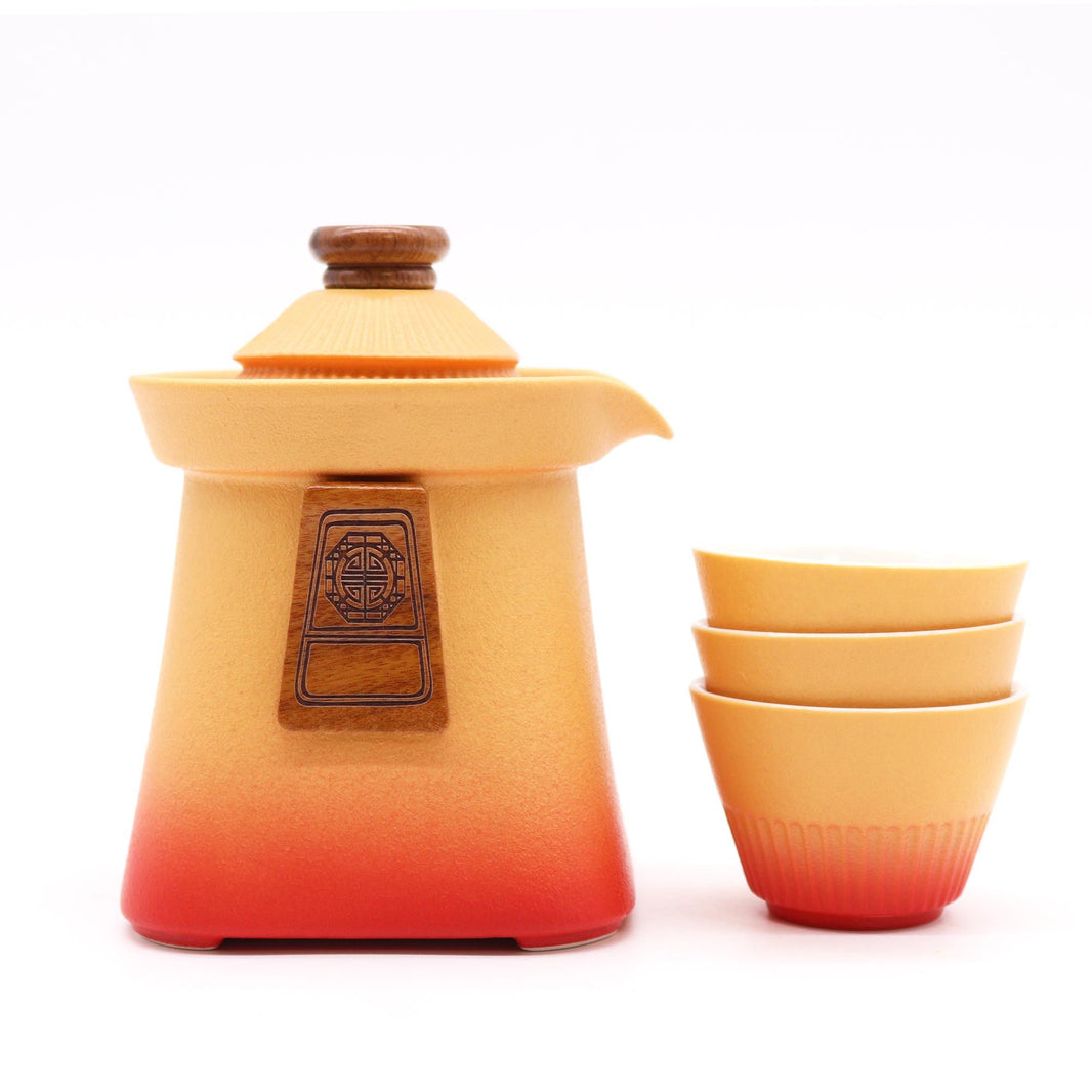 A modern ceramic teapot set in earthy orange tones, including a sleek, rounded teapot and three matching handleless cups.