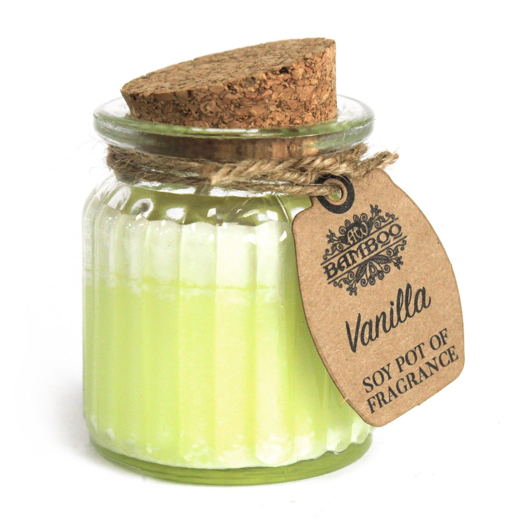 A small clear glass jar with white soy wax and a natural cork stopper, featuring a simple paper tag.