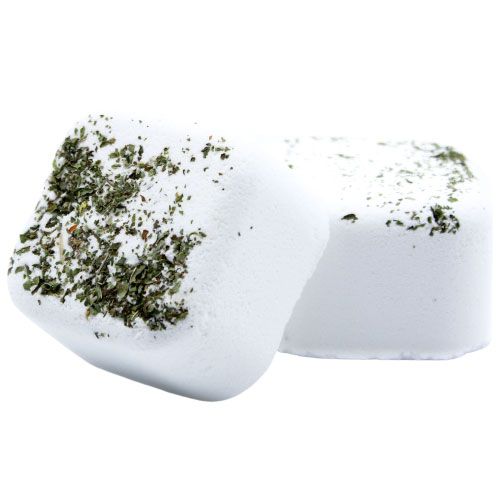 A white square shower steamer tablet infused with dried green herbs and invigorating citrus essential oils.