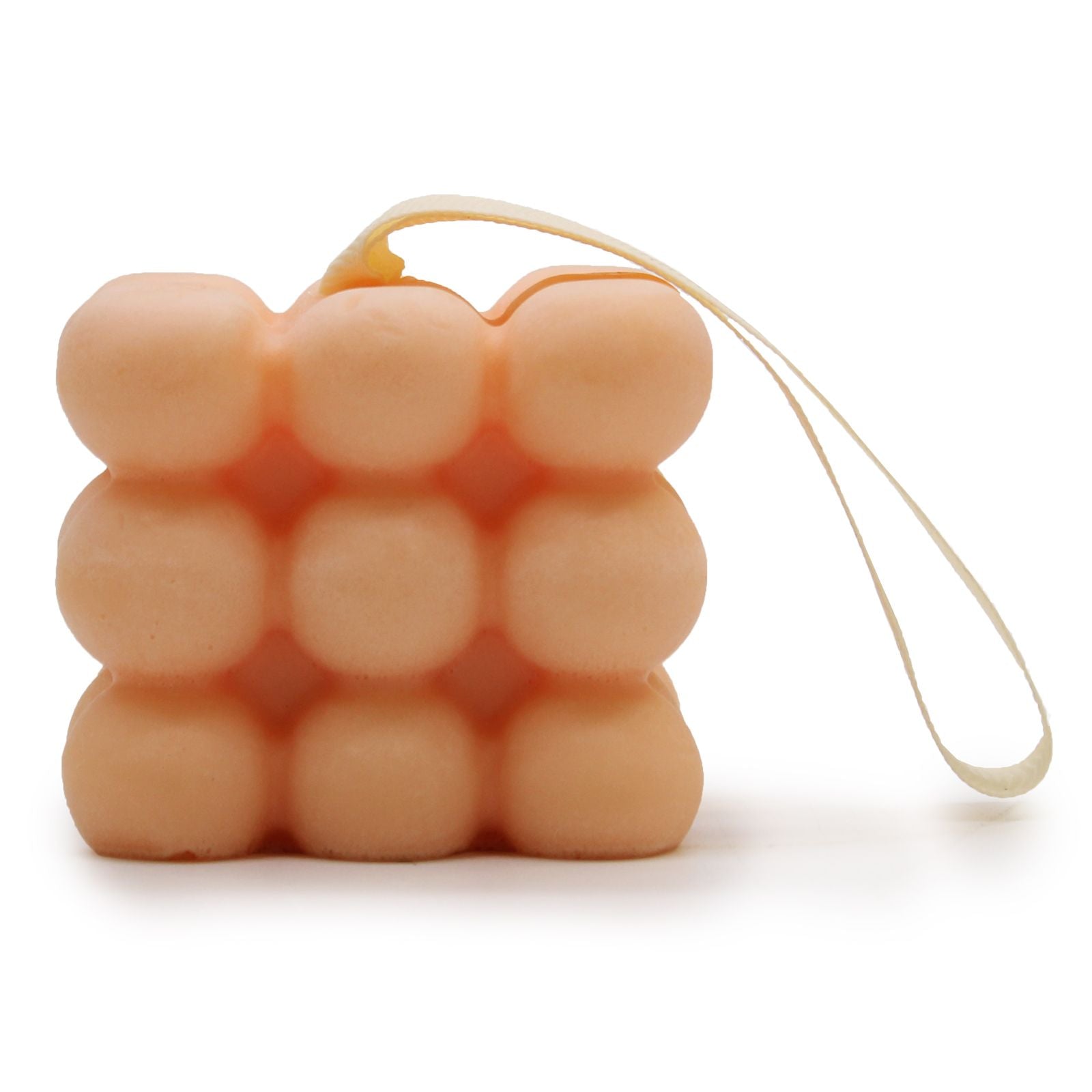 A peach-colored massage soap bar featuring relief nubs for a deep tissue feel, scented with Geranium and Sandalwood.
