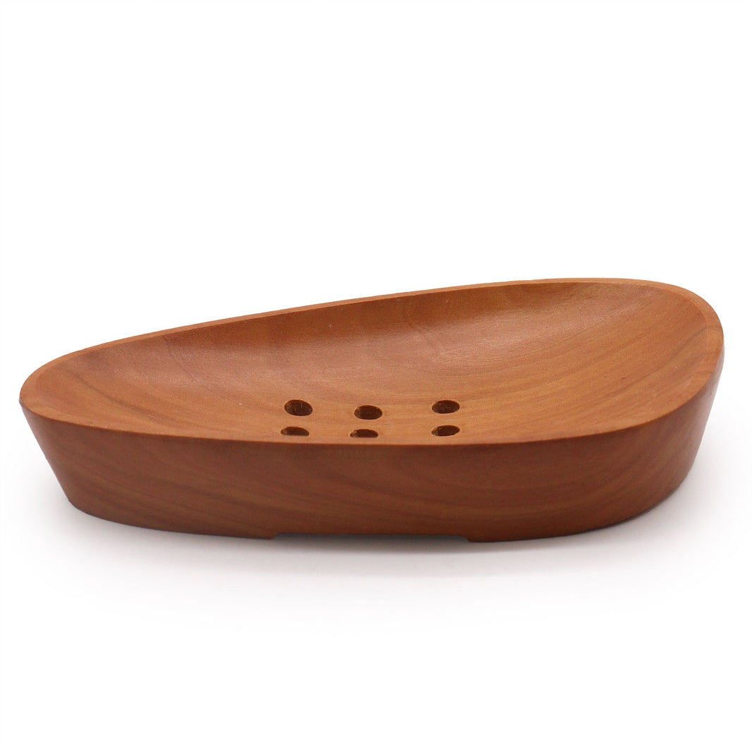 A smooth, pebble-shaped soap dish hand-carved from rich dark mahogany wood with drainage ridges.