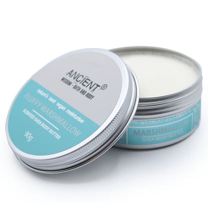 A 90g tin of light blue-tinted shea body butter with a sweet marshmallow fragrance and minimalist apothecary labeling.