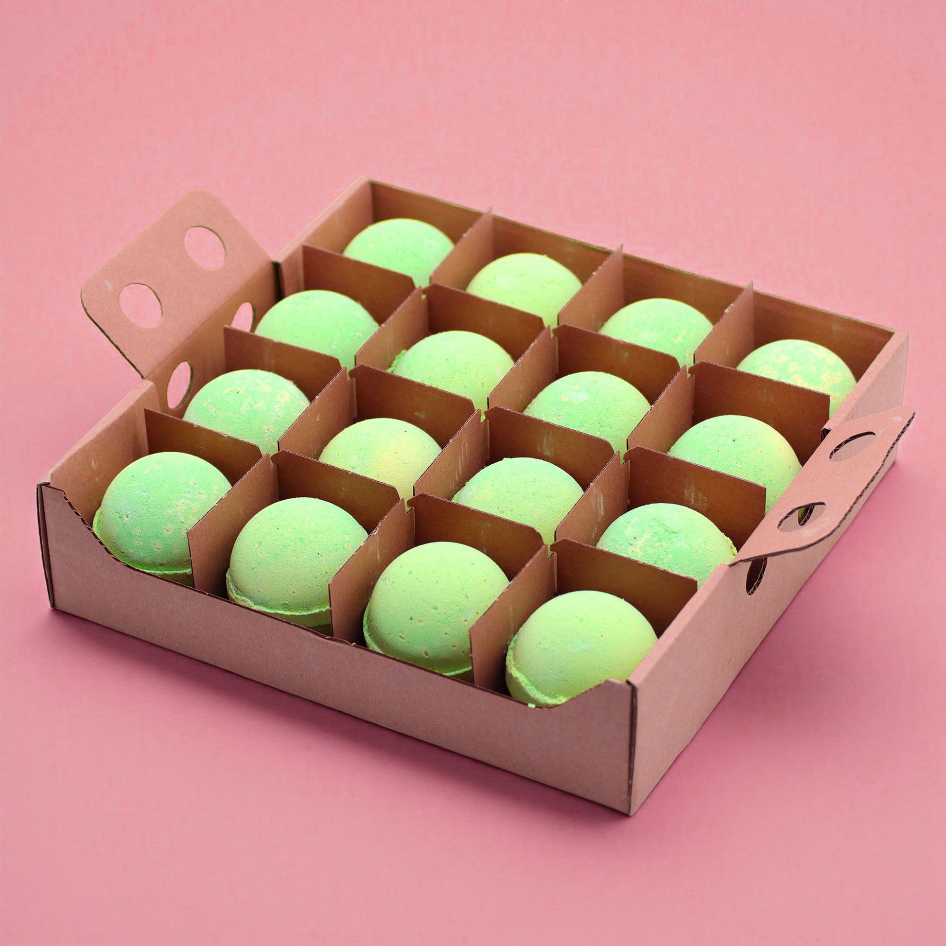 A bulk display box of 16 individually wrapped 180g green and white marbled peppermint and tea tree bath bombs.