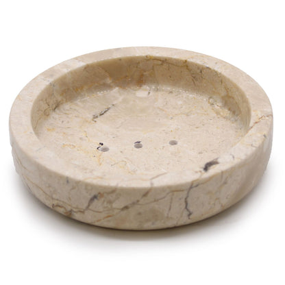 A flat, circular soap dish carved from polished natural honey-toned marble with elegant stone veining.