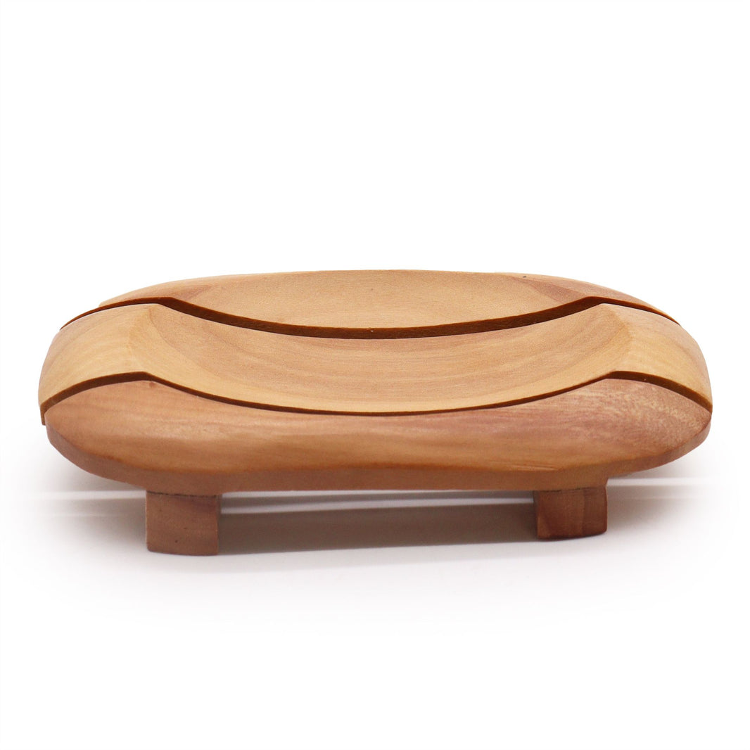 A handcrafted, rich mahogany wood soap dish with a rectangular outer frame and an oval recessed center featuring drainage holes.