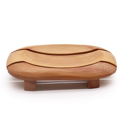 A handcrafted, rich mahogany wood soap dish with a rectangular outer frame and an oval recessed center featuring drainage holes.