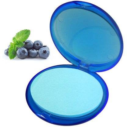 A round blue travel-ready container holding delicate blueberry-scented paper soap petals.