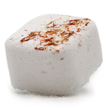 A decorative square shower steamer tablet with herbal speckles, designed to release relaxing essential oils through steam.