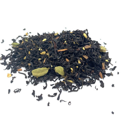 A generous quantity of high-quality organic black tea leaves blended with aromatic whole spices like cardamom and cloves.