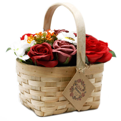 A large, ornate wicker basket overflowing with realistic red soap roses and decorative greenery.