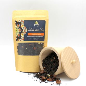 A cylindrical eco-friendly tea tube with a minimalist dark brown label next to a sample of loose-leaf herbal tea.