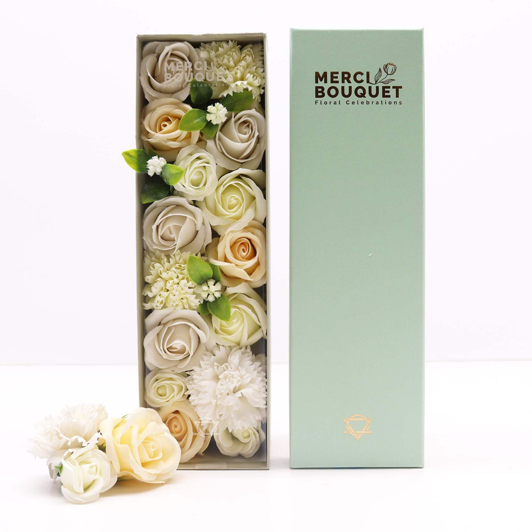A white long gift box containing a stunning arrangement of realistic white and ivory soap roses for weddings.