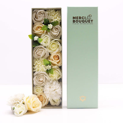 A white long gift box containing a stunning arrangement of realistic white and ivory soap roses for weddings.