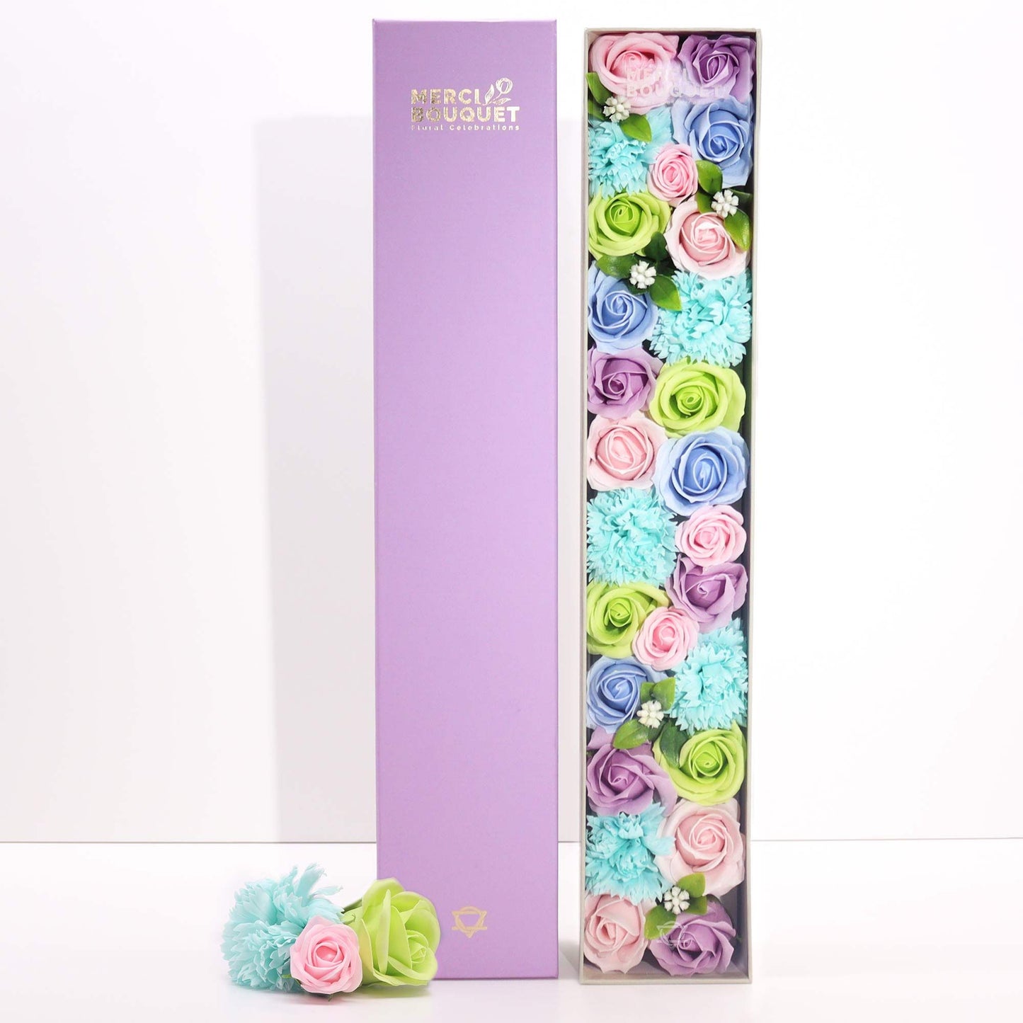 A tall, slim white gift box adorned with blue floral and baby-themed patterns, containing premium bath salts and soaps.