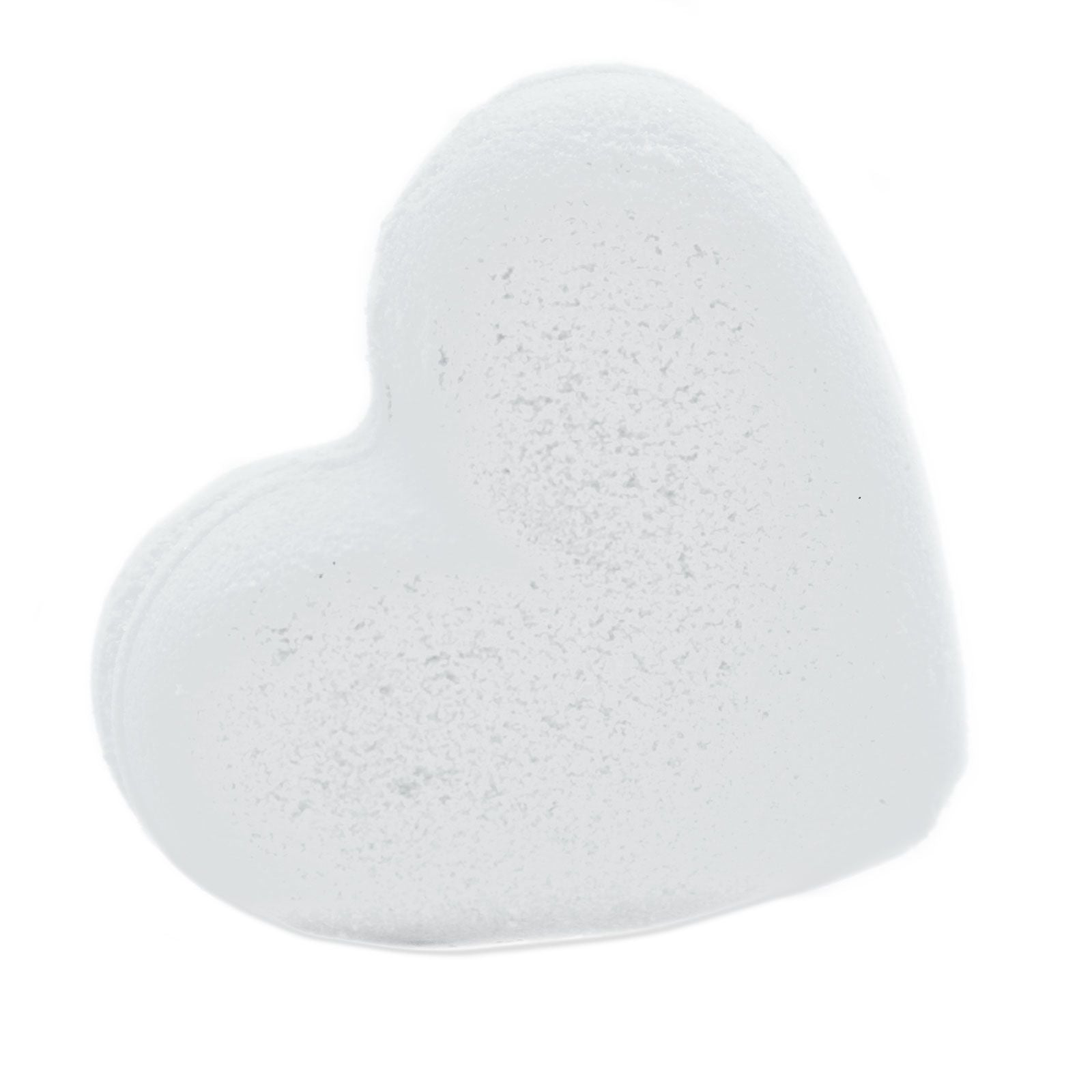 A white heart-shaped bath bomb scented with tropical coconut, designed for a moisturizing and romantic bath ritual.