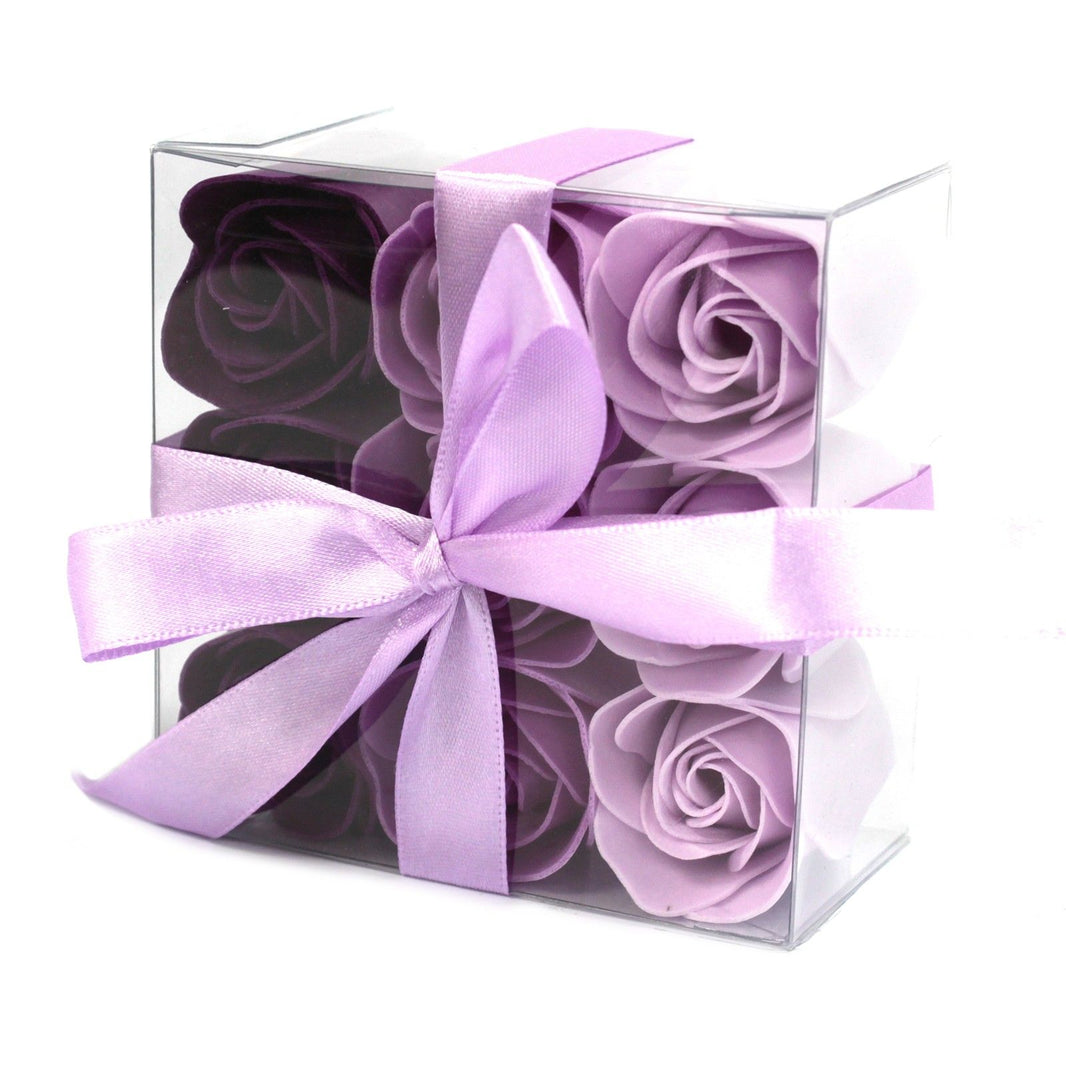 A square gift box containing nine realistic lavender-colored soap roses with a decorative bow.
