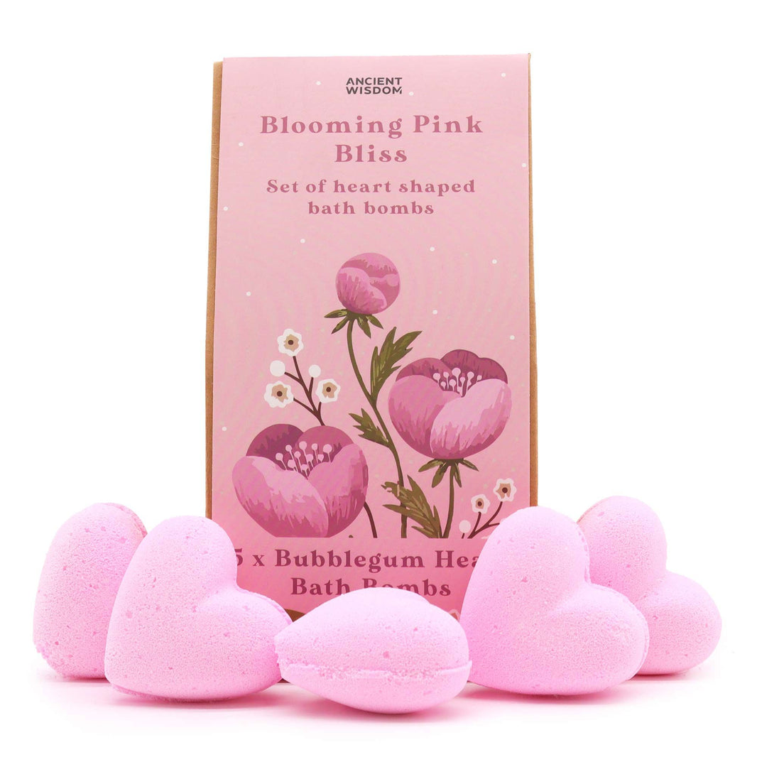 A decorative pink gift box filled with assorted heart-shaped bath bombs and botanical products tied with a pink bow.