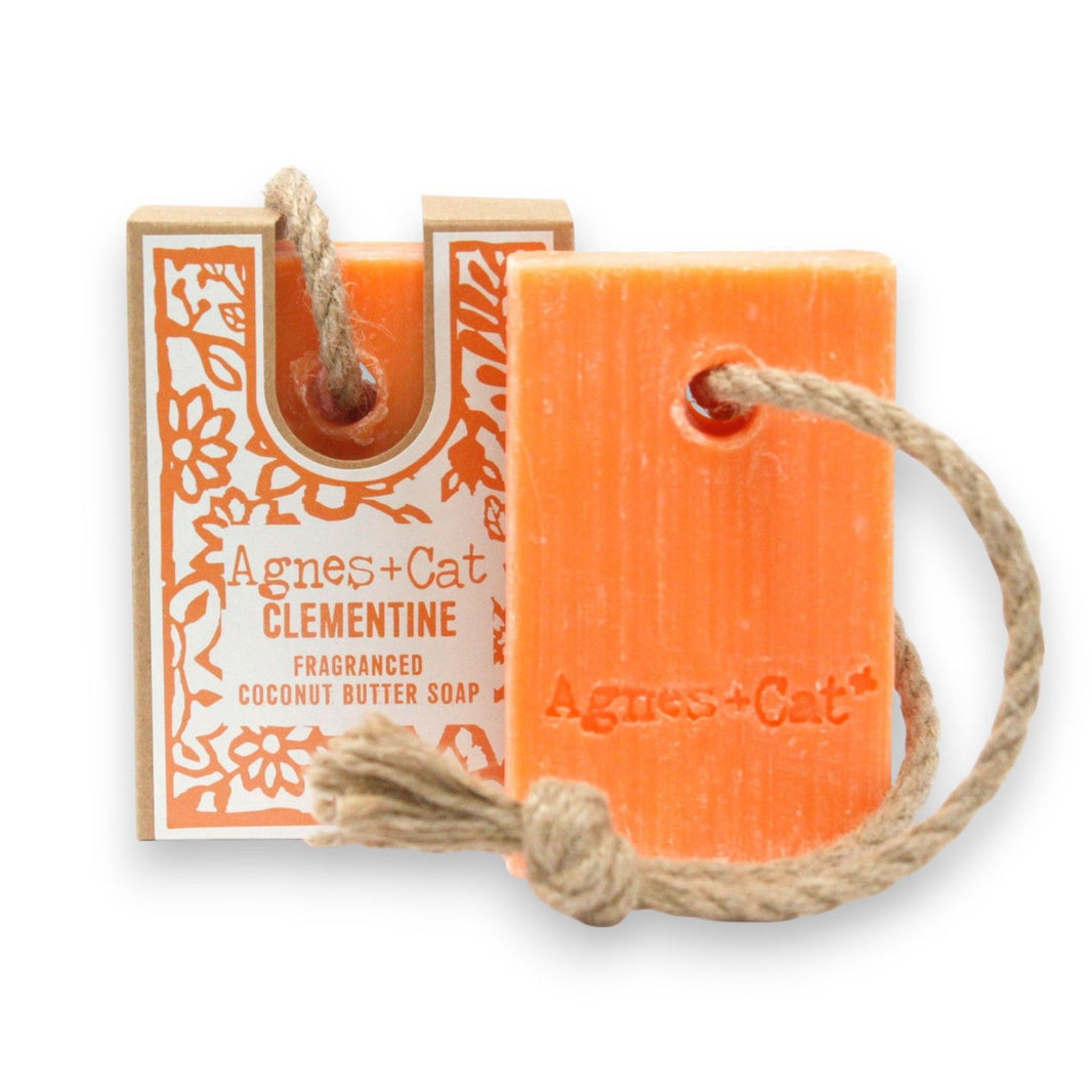 A bright orange and cream 150g artisan soap on a rope with a fresh citrus clementine scent and natural hanging cord.
