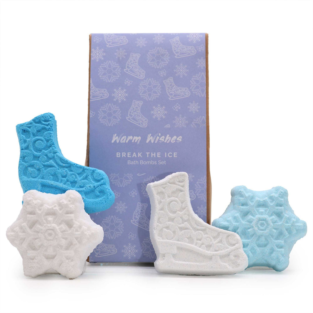 A snowy blue and white gift box containing four festive bath fizzers shaped like stars and holiday icons.