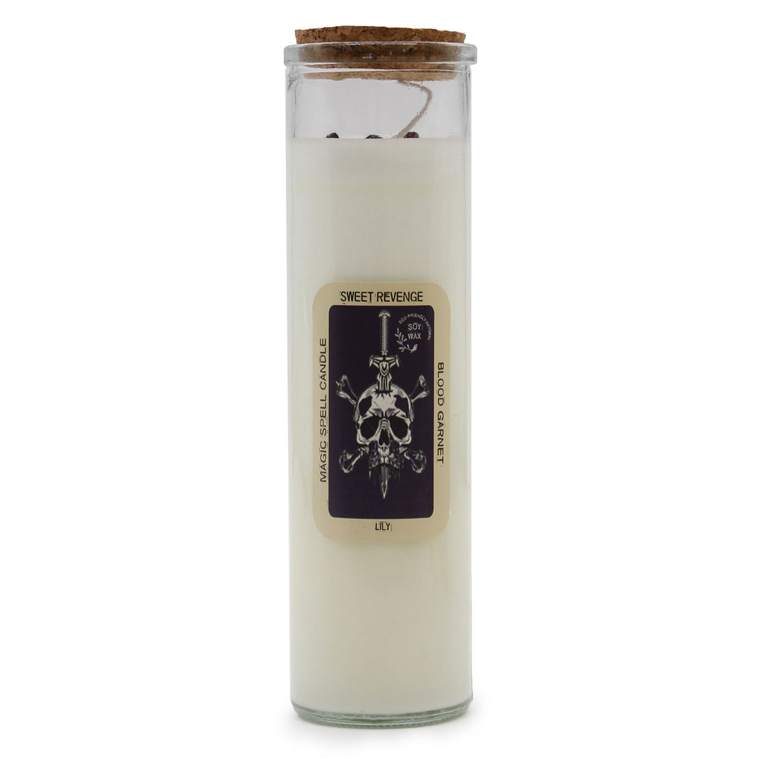 A tall decorative pillar candle labeled "Sweet Revenge" with dark, intricate mystical artwork on the paper wrapping.