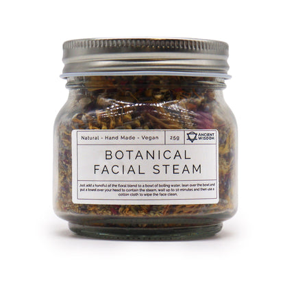 A glass jar filled with a premium blend of dried botanicals, flower petals, and herbs for a professional home facial steam.