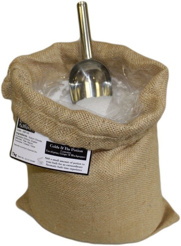 A large, rustic brown hessian sack overflowing with therapeutic herbal bath salts for congestion relief and wellness.