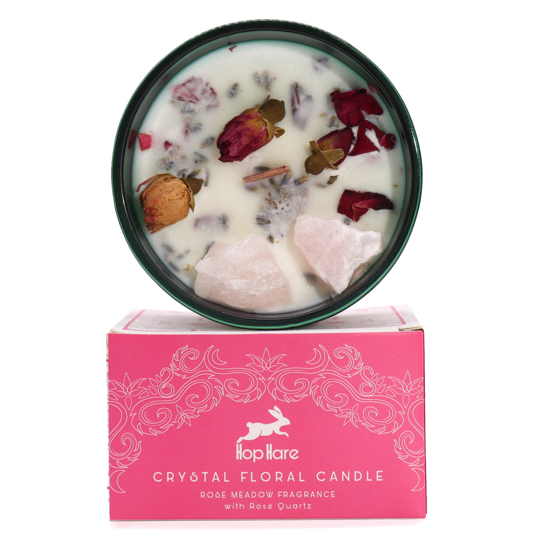 The Lovers crystal candle in a pink glass jar decorated with raw gemstones and dried flower elements for manifestation.