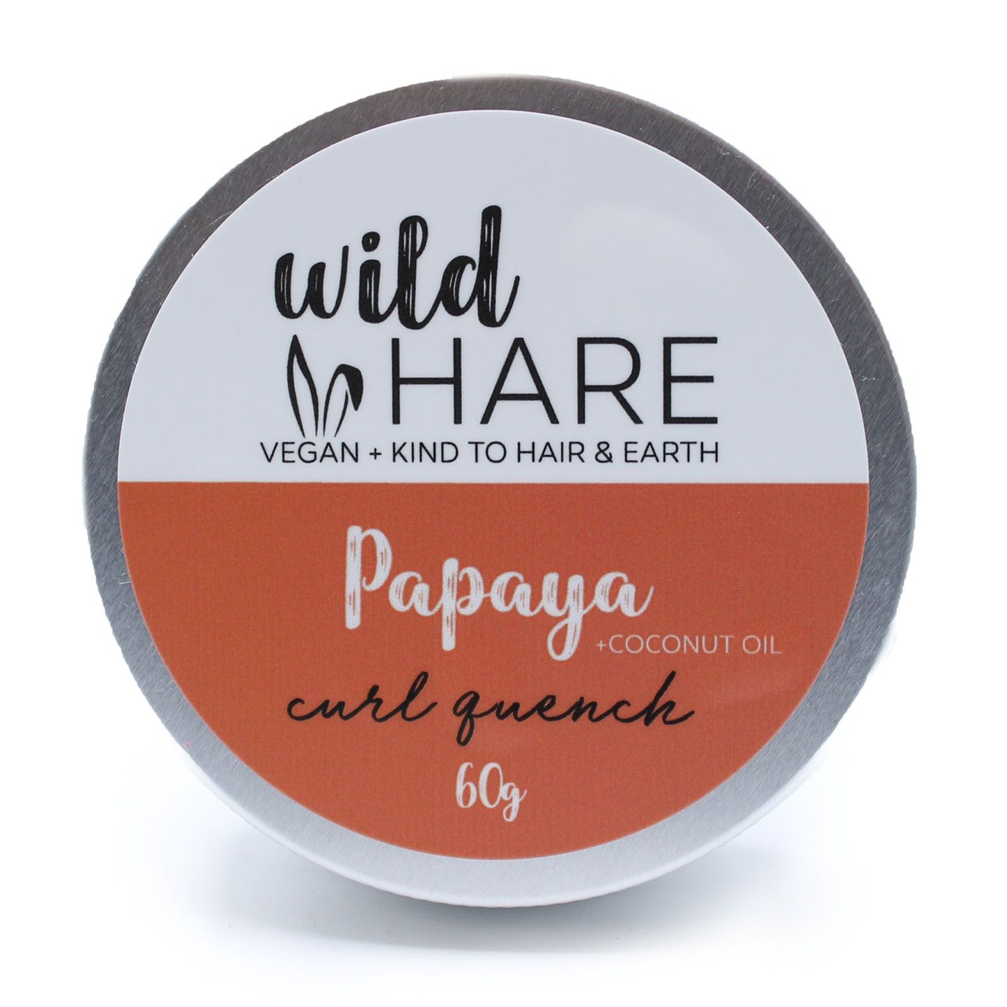 A 60g Wild Hare solid shampoo bar with an orange label, scented with tropical papaya and stored in a travel-ready tin.