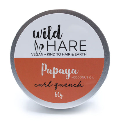 A 60g Wild Hare solid shampoo bar with an orange label, scented with tropical papaya and stored in a travel-ready tin.