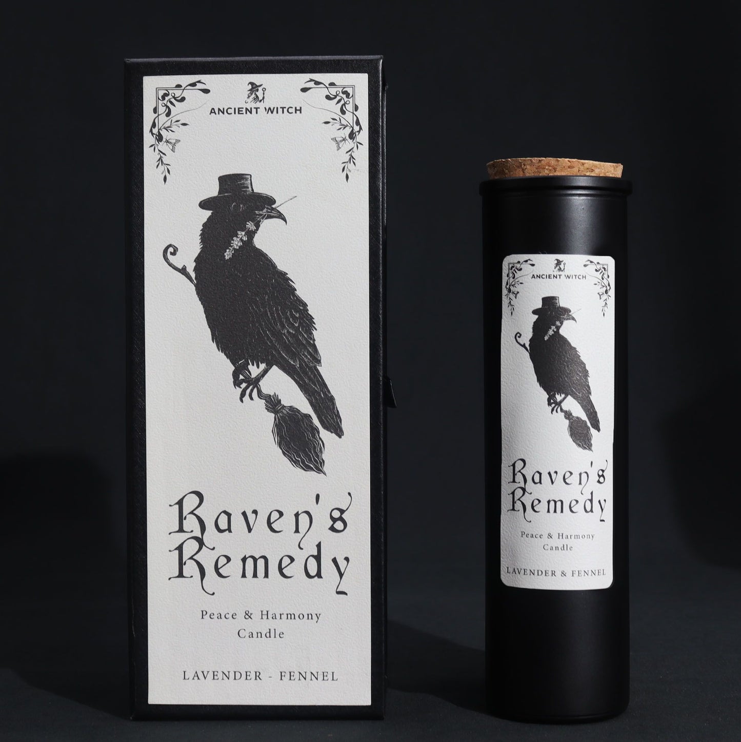 A sleek black pillar candle in a decorative black cardboard sleeve featuring a raven and occult symbols.