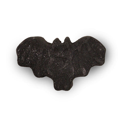 A detailed black bath bomb shaped like a bat with spread wings, perfect for a spooky and atmospheric bath experience.