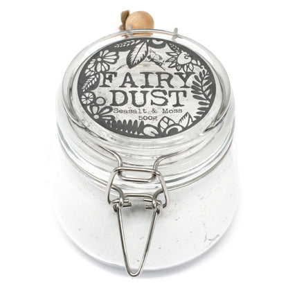 A large apothecary-style glass jar with a wooden spoon, filled with 500g of white Seasalt and Moss bath fizzing powder.