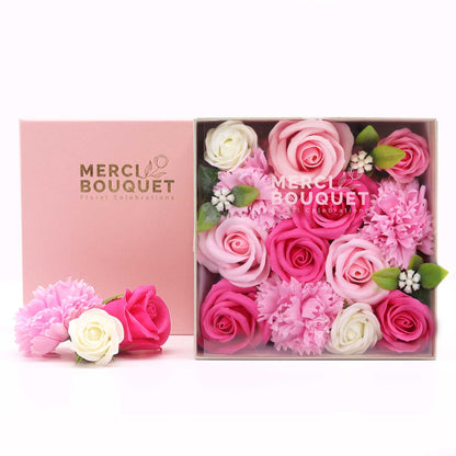 A pink square gift box filled with soft pink soap flowers, perfect for baby showers and new parents.