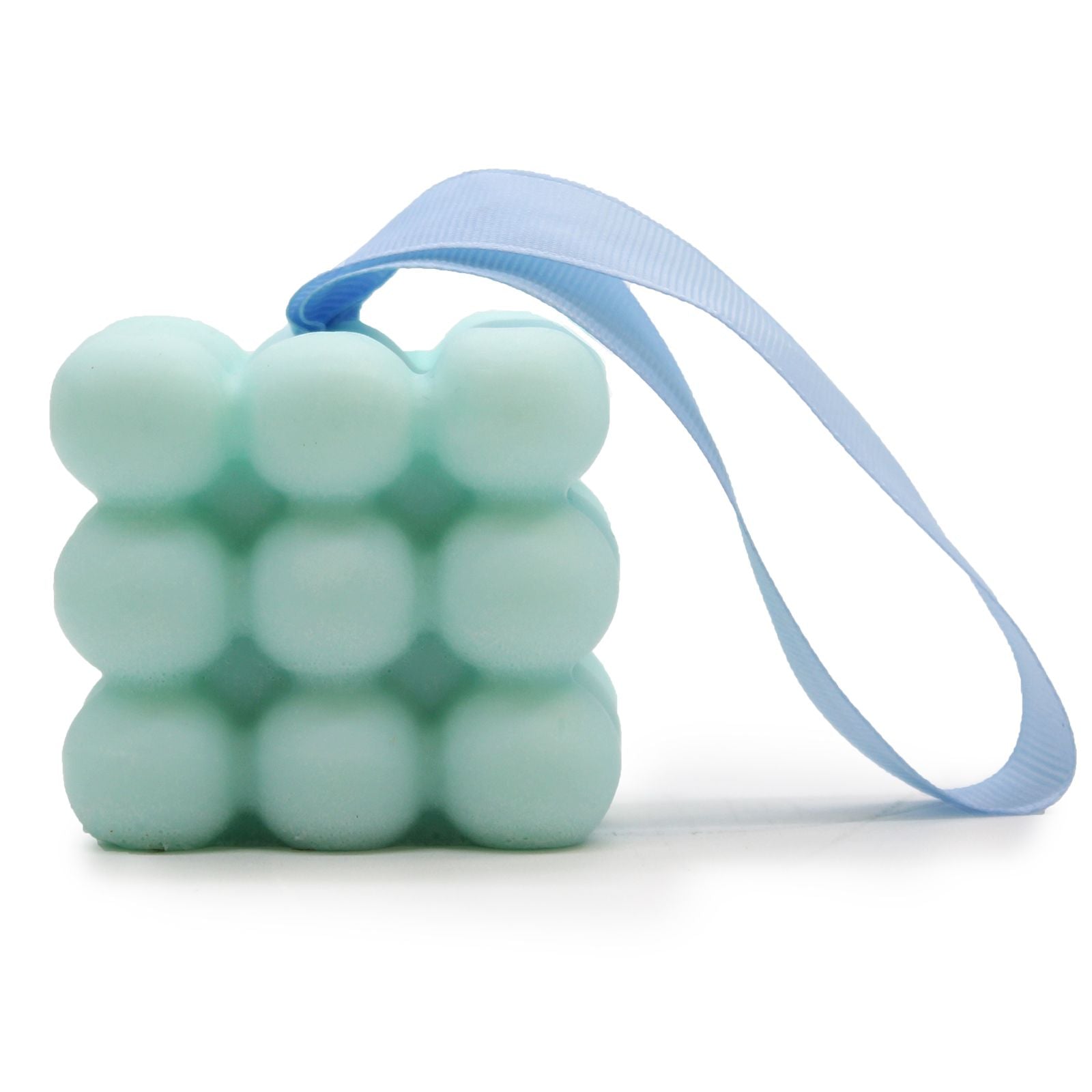 A blue massage soap bar with textured nubs for muscle relief, scented with tea tree and aloe vera, in its individual box.