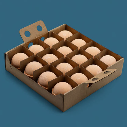 A cardboard display case holding 16 individually wrapped 180g orange-colored Tangerine and Grapefruit bath bombs.