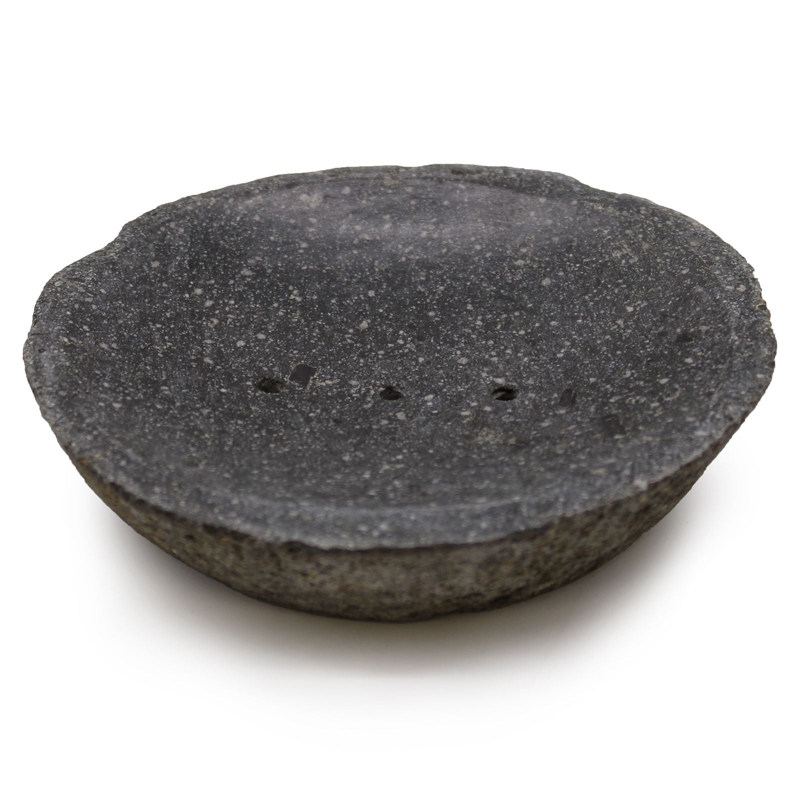 A dark, hand-carved natural riverstone soap dish with a smooth hollow and organic exterior shape.