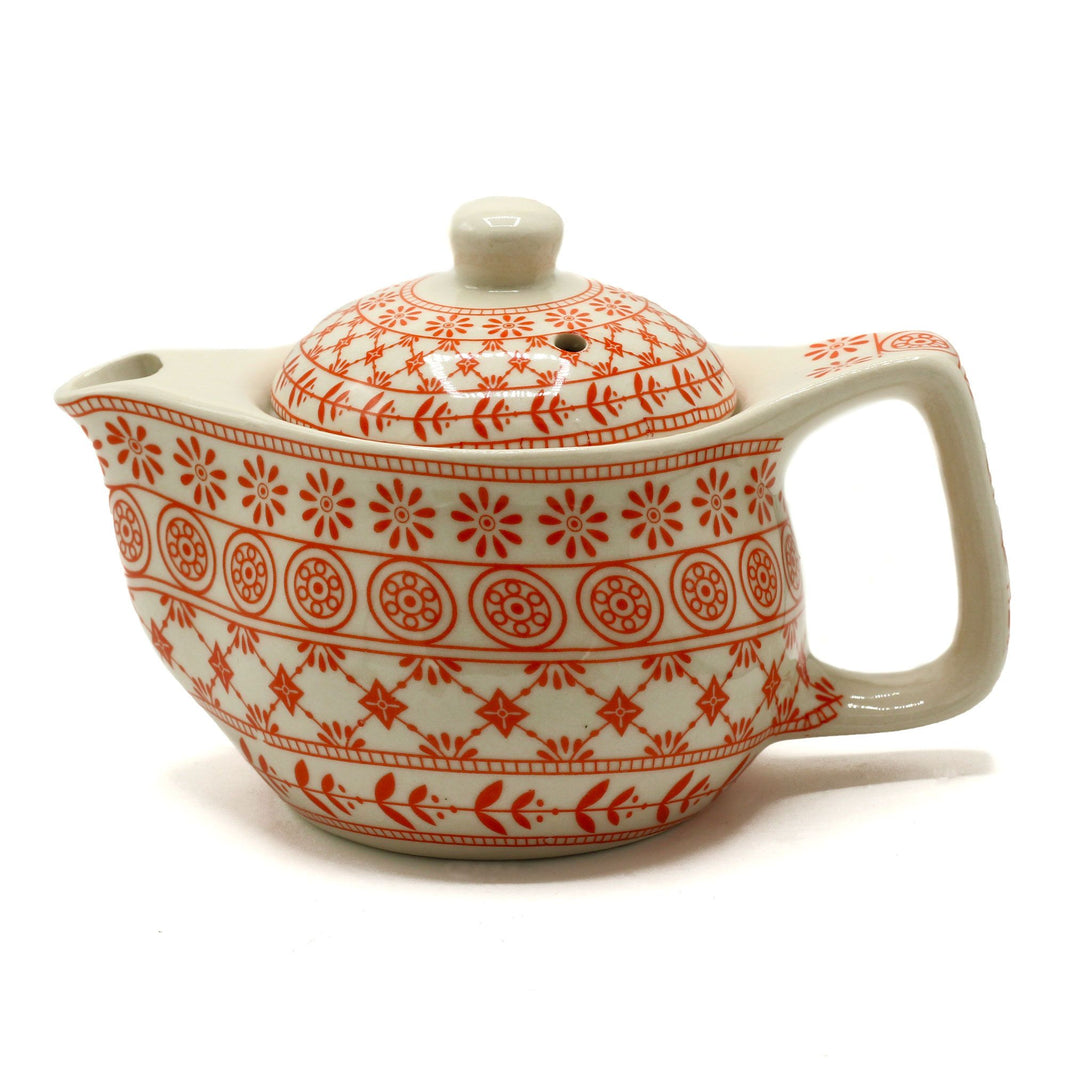 A small terracotta-colored ceramic teapot with a detailed geometric relief pattern across the body.