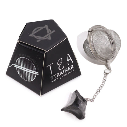 Tea infuser with a raw black obsidian gemstone charm, designed for protective and mindful tea ceremonies.