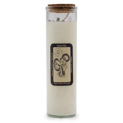 A tall white pillar candle featuring a vintage-style 'Seduction' label with mystical botanical illustrations.
