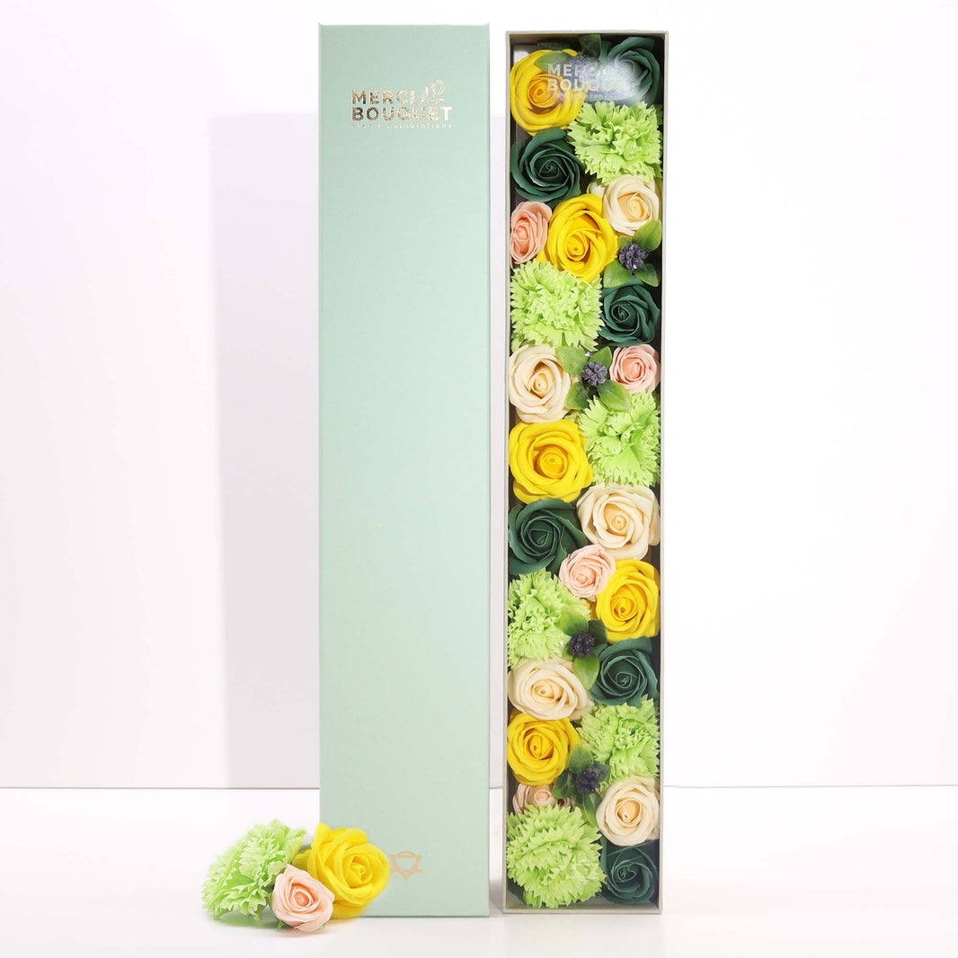 A very long rectangular gift box showcasing a massive arrangement of realistic yellow and green soap flowers.